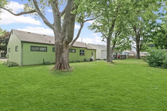 a view of a house with a tree in a yard