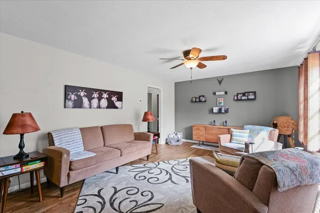 a living room with furniture and a chandelier