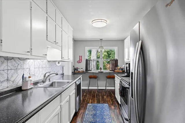 a kitchen with sink cabinets and window