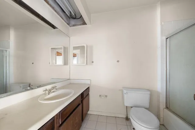 a bathroom with a sink a toilet and mirror