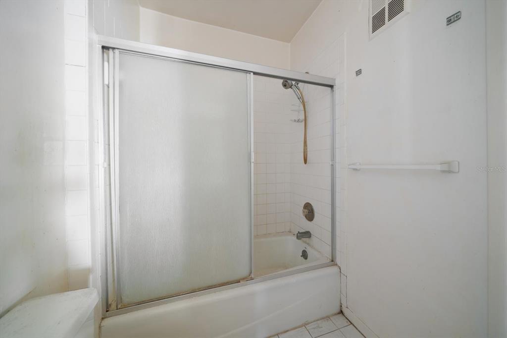 829 East Gulf Boulevard, Unit 107 Indian Rocks Beach, FL 33785 - Photo 21 of 43 a bathroom with a shower and a bath tub