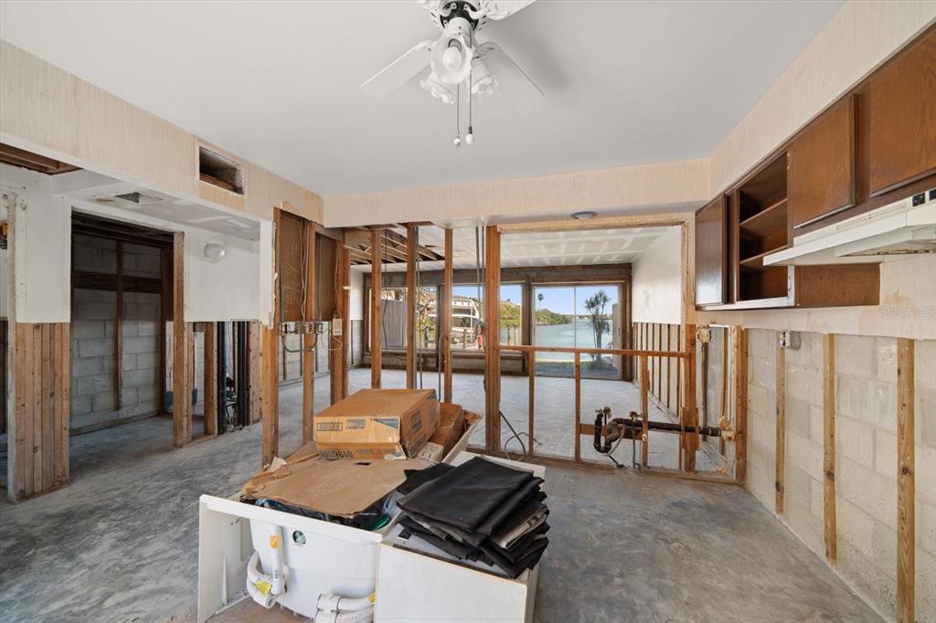 829 East Gulf Boulevard, Unit 107 Indian Rocks Beach, FL 33785 - Photo 9 of 43 a room with chandelier fan and windows