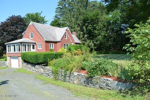 a view of a house with yard and sitting area