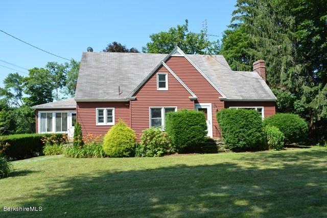 1603 North Main Road Otis, MA 01253 - Photo 3 of 17 a front view of a house with a yard