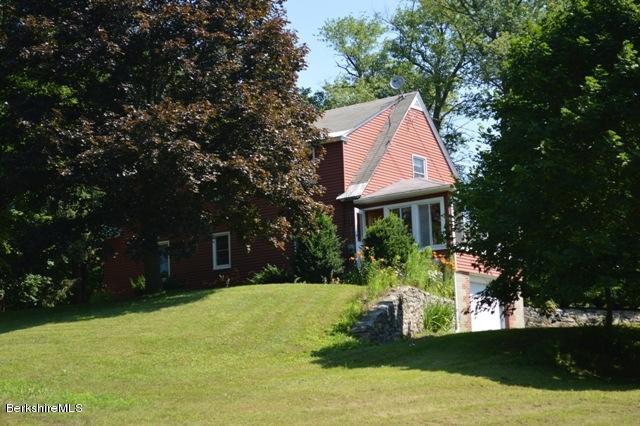 1603 North Main Road Otis, MA 01253 - Photo 9 of 17 a front view of a house with a yard and trees