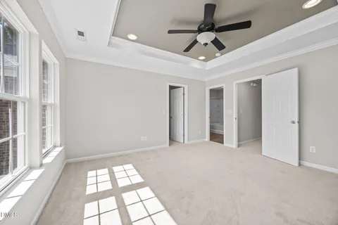 a view of a hallway with wooden floor and entryway