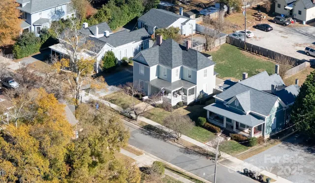 an aerial view of multiple houses with yard