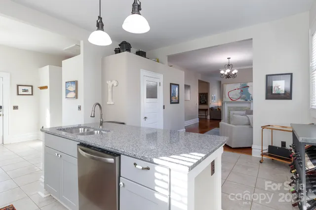 a kitchen with stainless steel appliances granite countertop a sink and a refrigerator