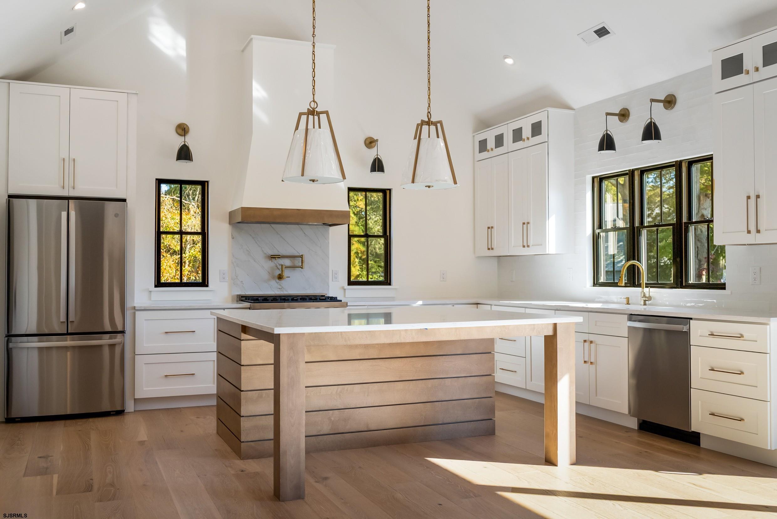 11 Evio John Court Marmora, NJ 08223 - Photo 14 of 49 a kitchen with a stove refrigerator and a sink