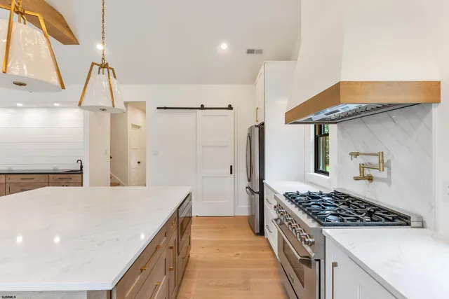 a kitchen with a stove and a window