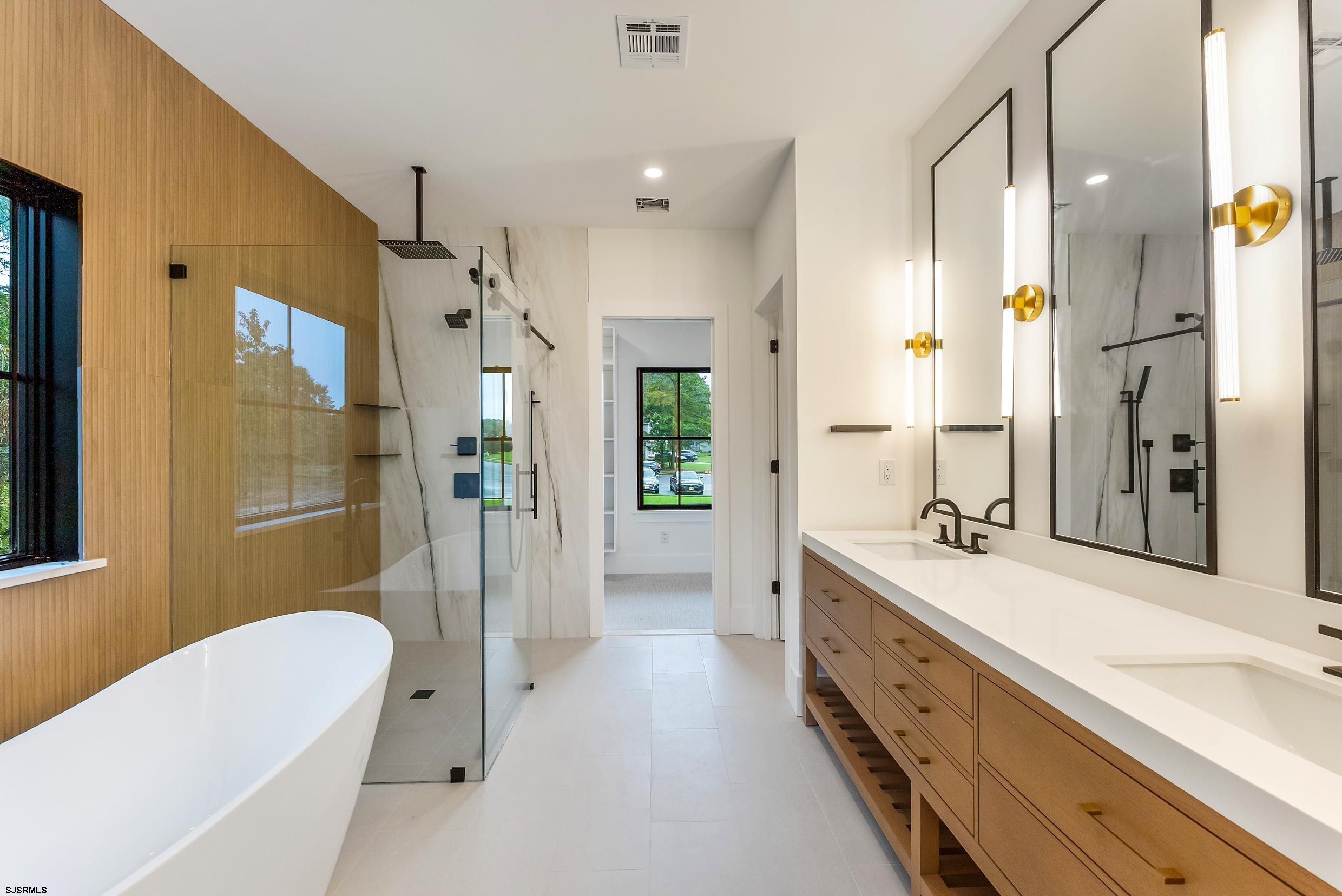 11 Evio John Court Marmora, NJ 08223 - Photo 27 of 49 a spacious bathroom with a granite countertop sink mirror shower and bathtub