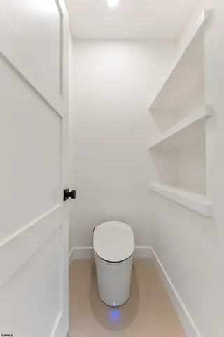 a white bath tub sitting in a bathroom next to a window