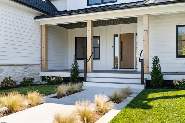 a view of a porch with wooden floor and floor to ceiling window