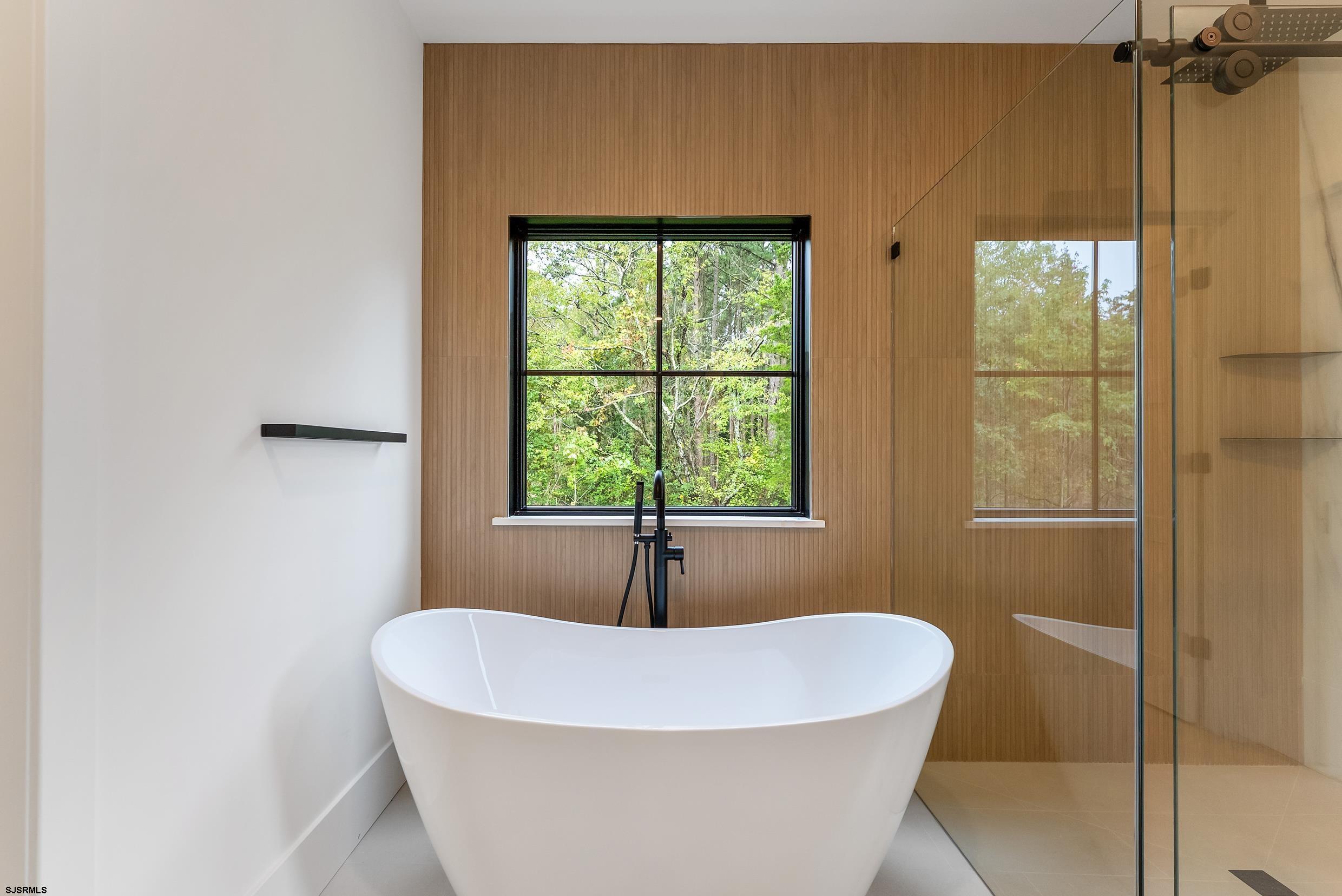 11 Evio John Court Marmora, NJ 08223 - Photo 31 of 49 a white bath tub sitting in a bathroom next to a window