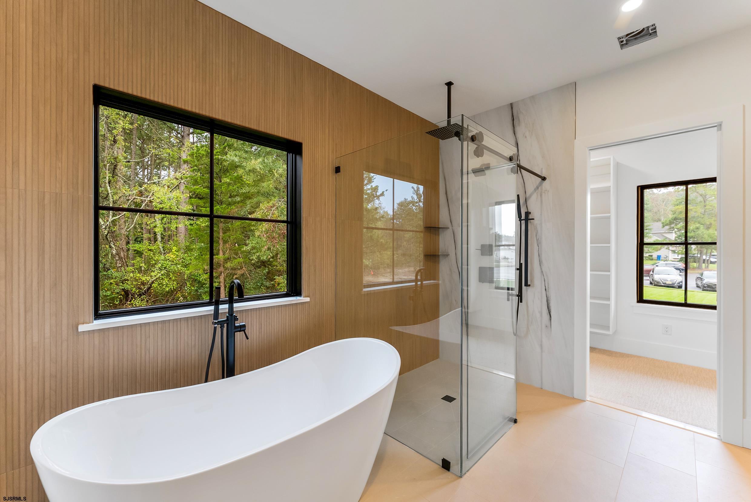 11 Evio John Court Marmora, NJ 08223 - Photo 33 of 49 a bathroom with a tub and glass door