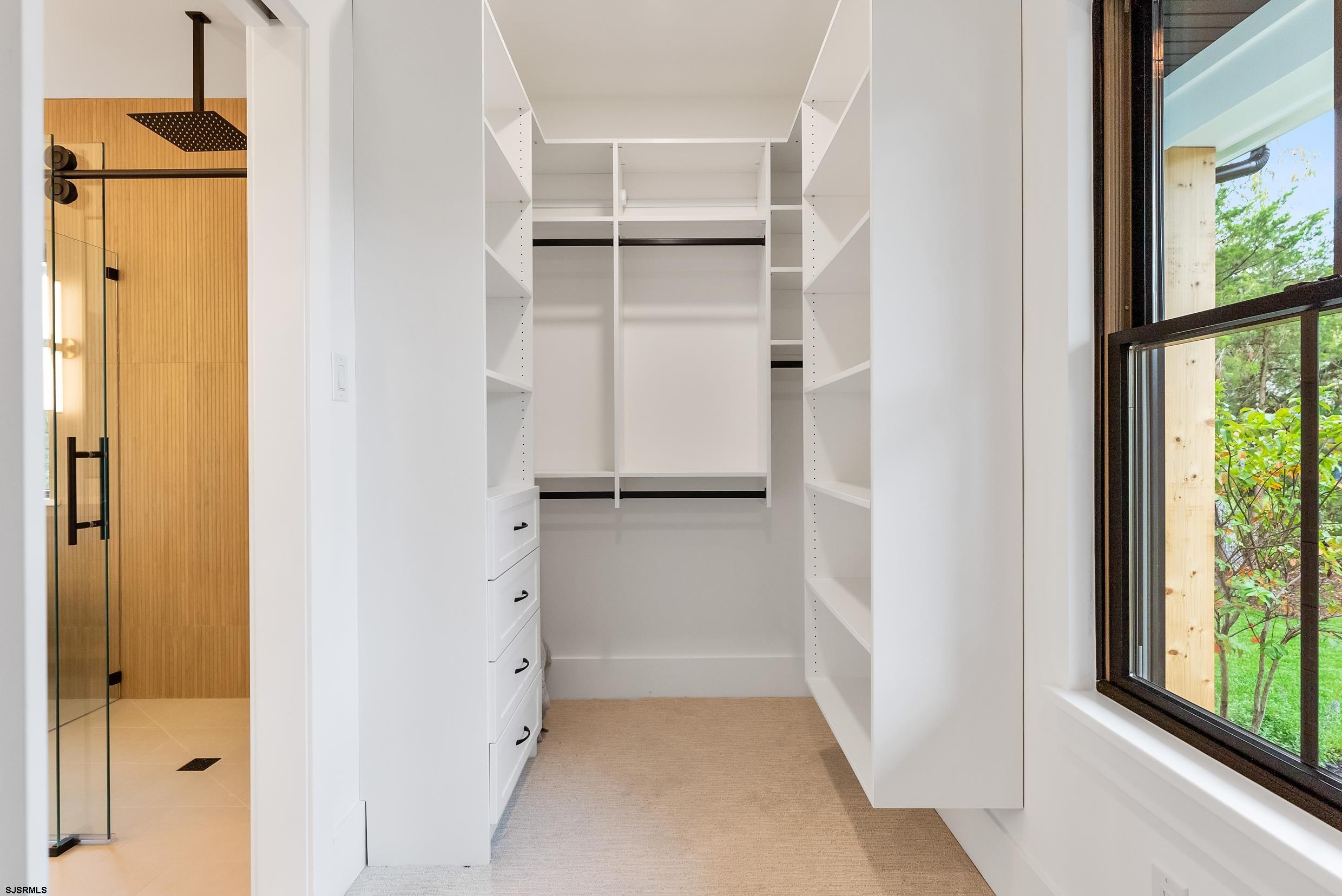 11 Evio John Court Marmora, NJ 08223 - Photo 35 of 49 a view of walk in closet with empty racks