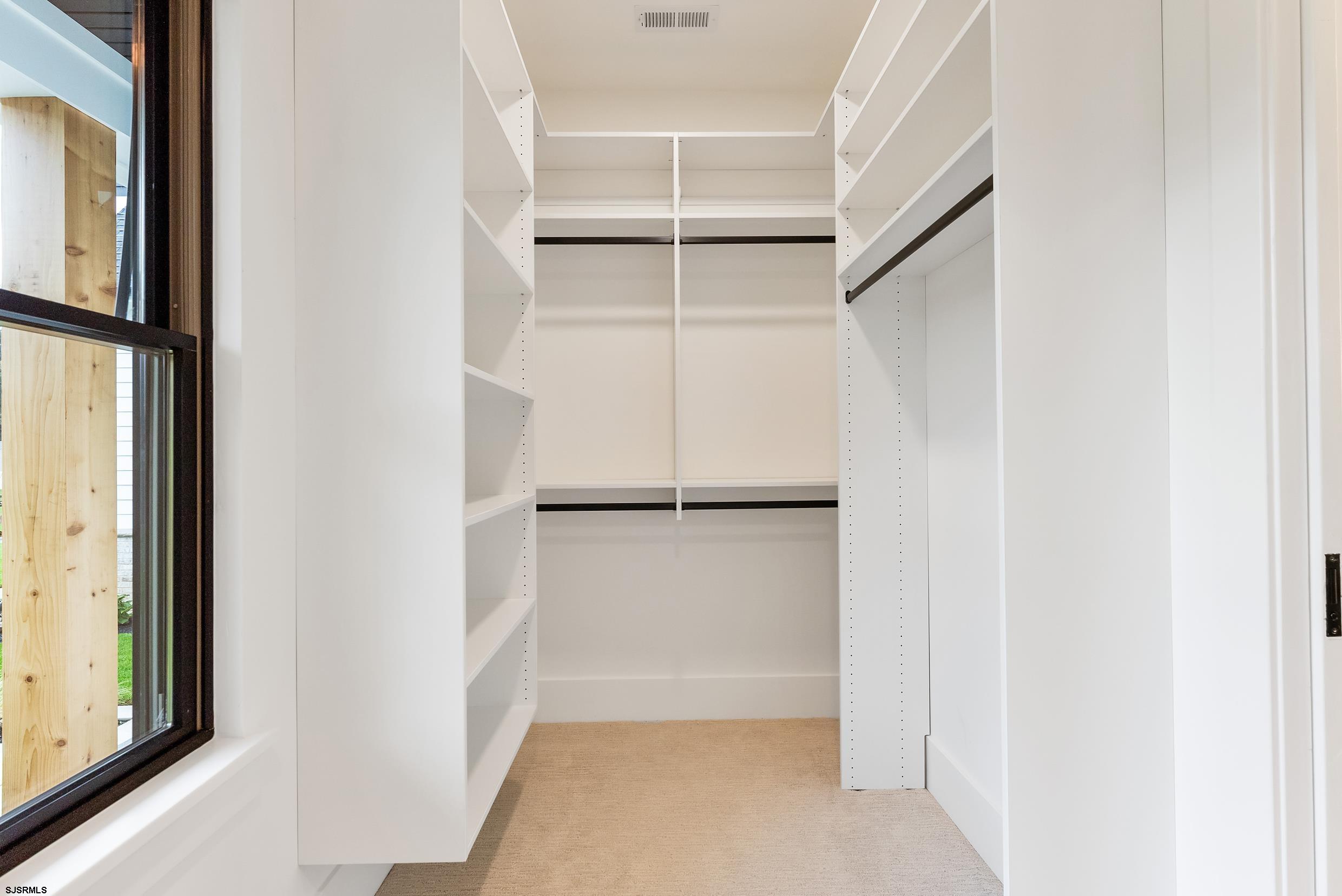 11 Evio John Court Marmora, NJ 08223 - Photo 36 of 49 a view of walk in closet with empty racks