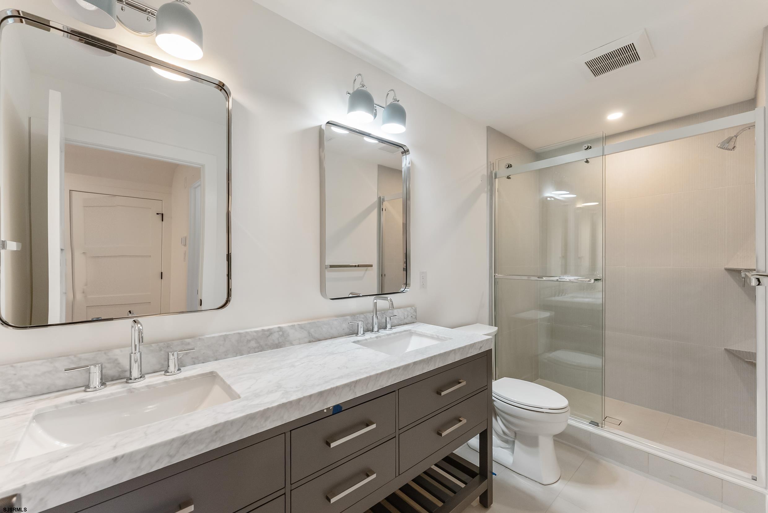 11 Evio John Court Marmora, NJ 08223 - Photo 42 of 49 a bathroom with a granite countertop sink toilet and shower