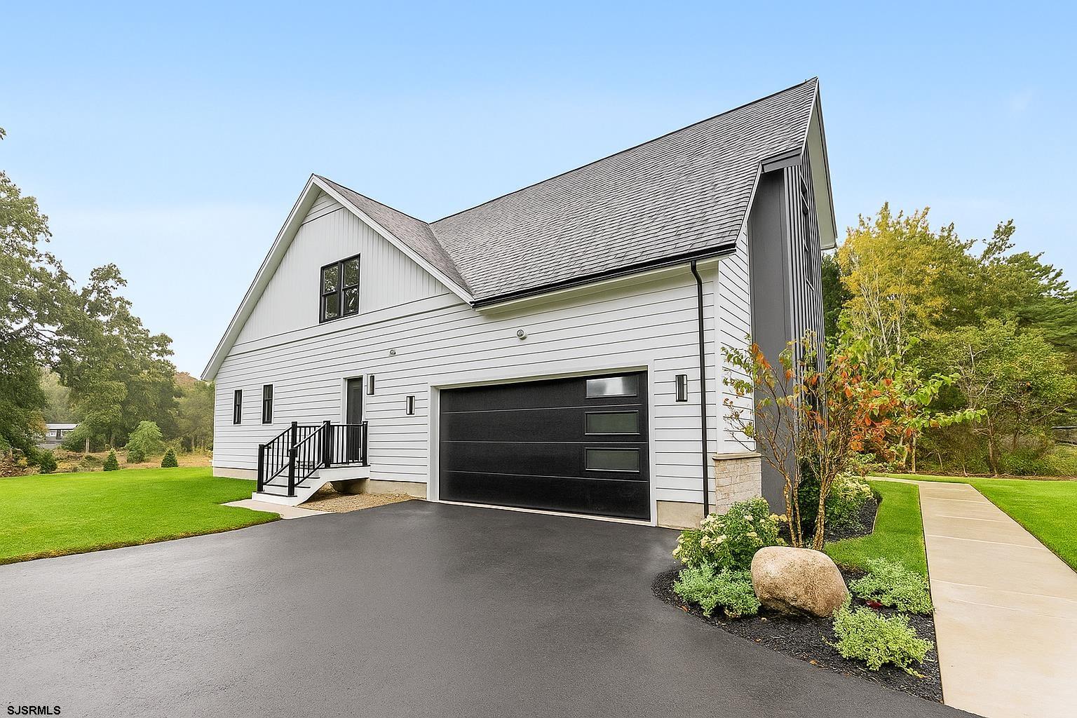 11 Evio John Court Marmora, NJ 08223 - Photo 47 of 49 a view of a house with a yard and garage