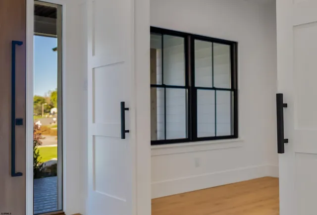 a view of a room with wooden floor and window
