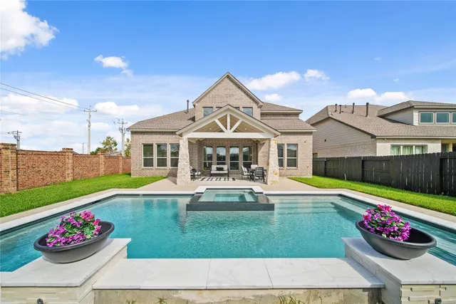 a front view of a house with a garden and plants