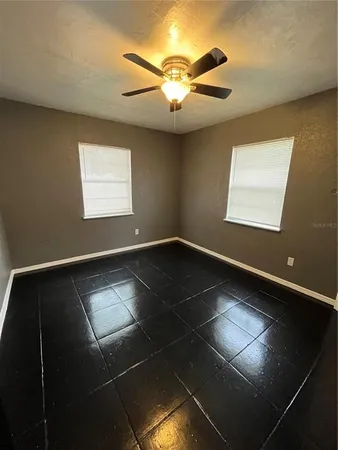 a kitchen with stainless steel appliances a stove a sink and white cabinets