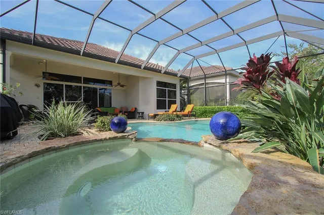 a view of a backyard with a table and chairs under an umbrella