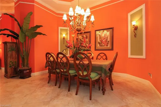 a view of a dining room with furniture and a chandelier