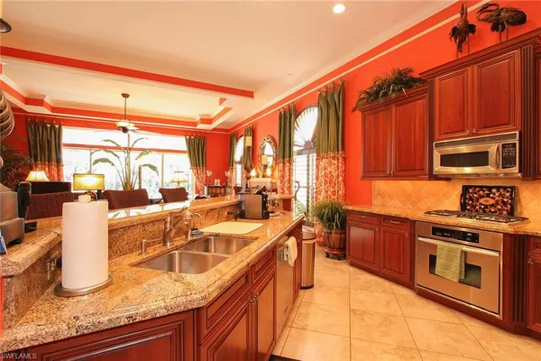 a kitchen with stainless steel appliances granite countertop a sink and a stove
