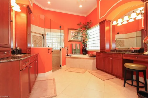 a large kitchen with kitchen island granite countertop a large counter top space and stainless steel appliances