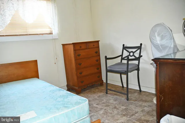 a bedroom with a bed and a mirror