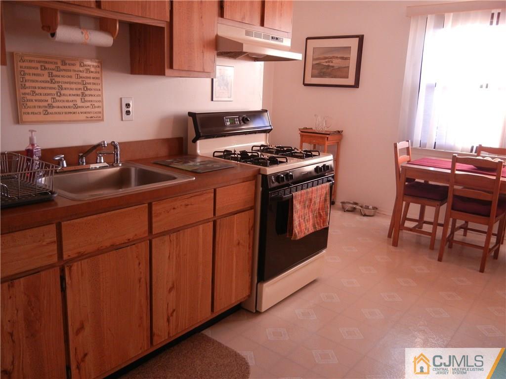 1643 Raspberry Court Edison, NJ 08817 - Photo 6 of 11 a kitchen with stainless steel appliances granite countertop a stove a sink and a microwave