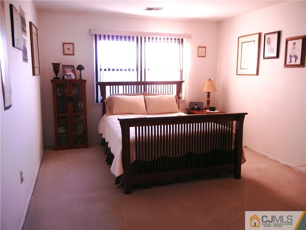 1643 Raspberry Court Edison, NJ 08817 - Photo 8 of 11 a bedroom with a bed and a window