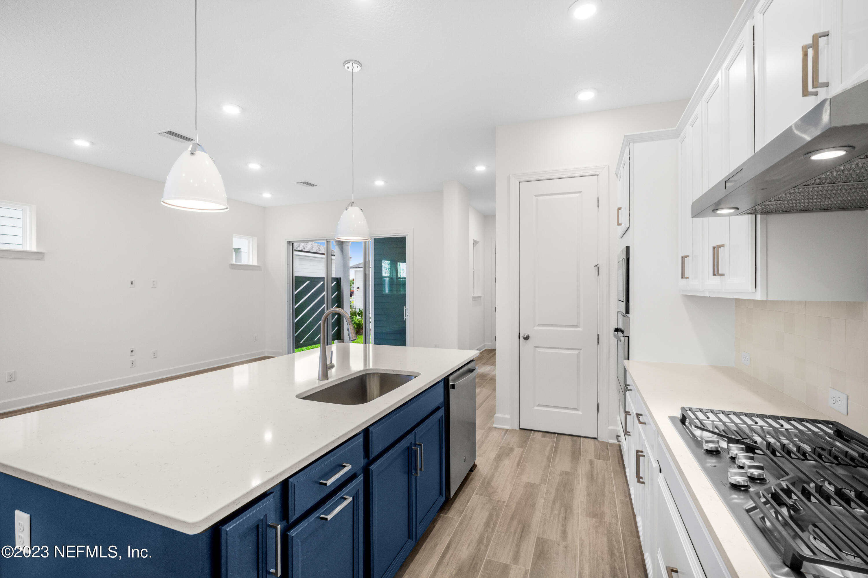 11015 Cosmic Way Jacksonville, FL 32256 - Photo 3 of 9 a kitchen with kitchen island a sink stainless steel appliances and cabinets