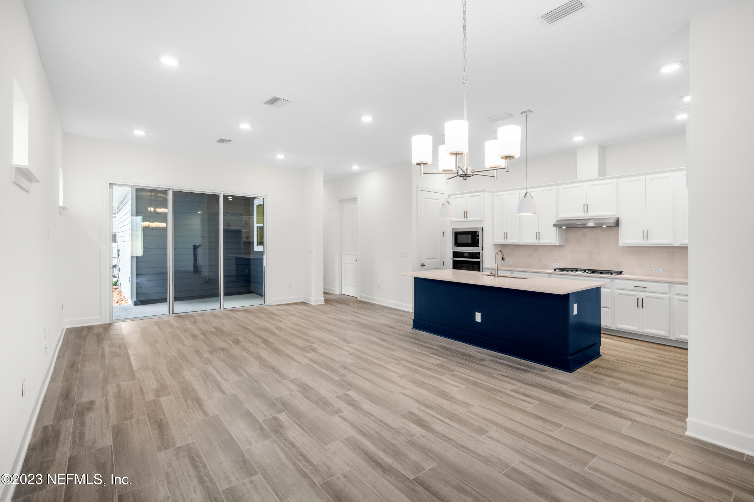 11015 Cosmic Way Jacksonville, FL 32256 - Photo 4 of 9 a large kitchen with stainless steel appliances granite countertop a large counter top a sink refrigerator and cabinets