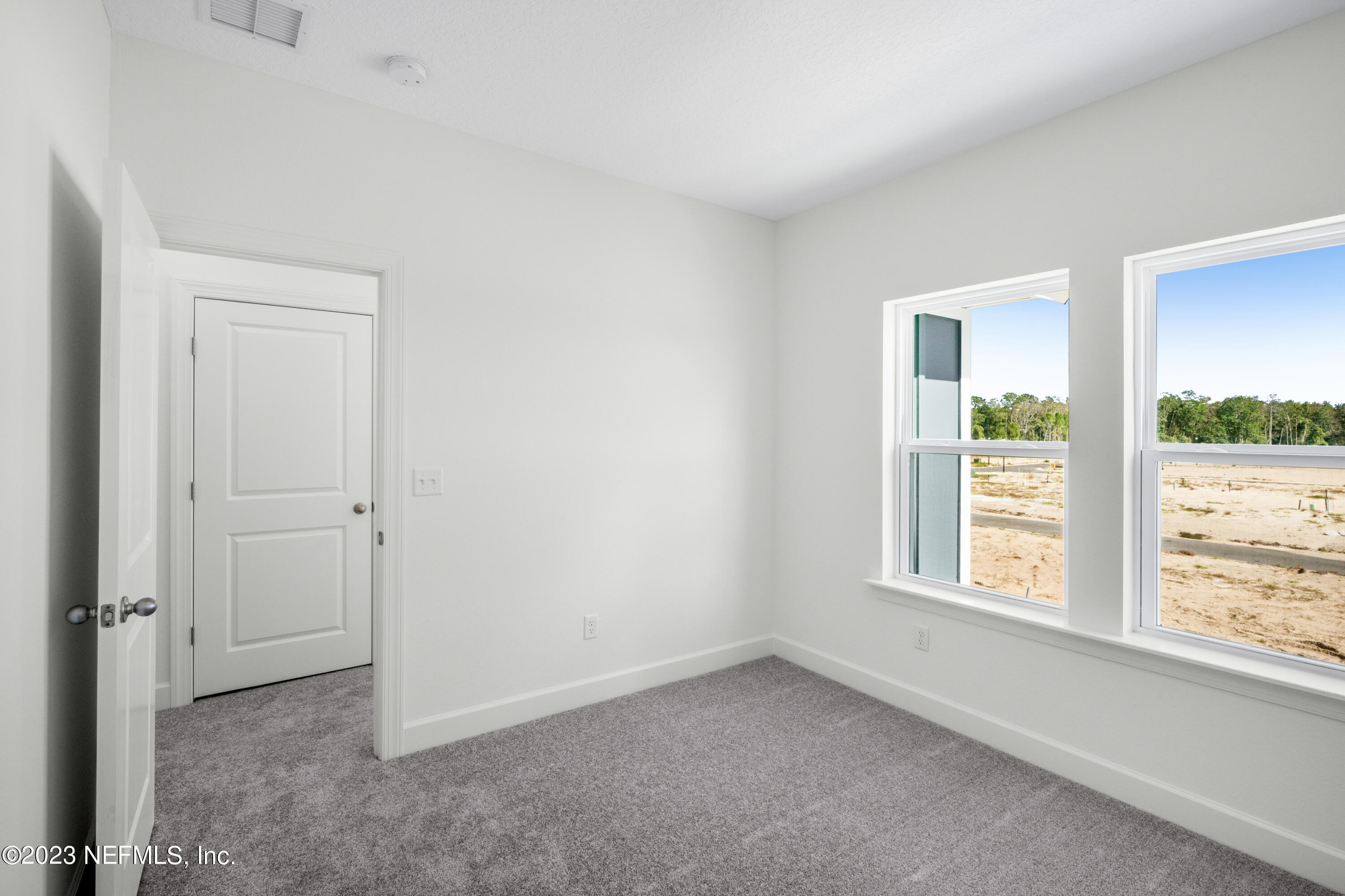 11015 Cosmic Way Jacksonville, FL 32256 - Photo 7 of 9 an empty room with a window