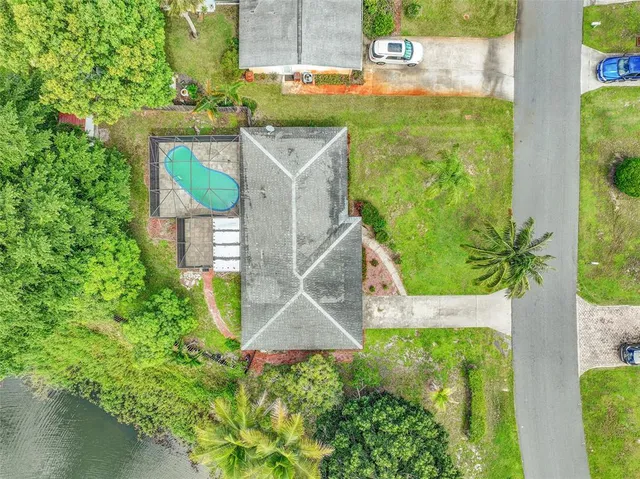 an aerial view of a house with a yard