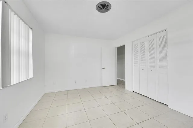 a view of an empty room and a window