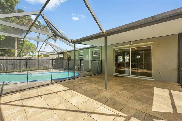 a view of a backyard with swimming pool