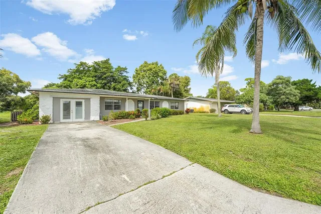 a front view of house with yard and green space