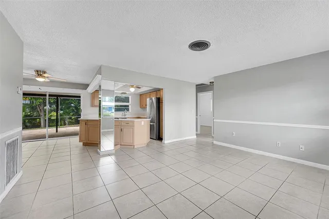 a view of a kitchen with furniture and an empty room