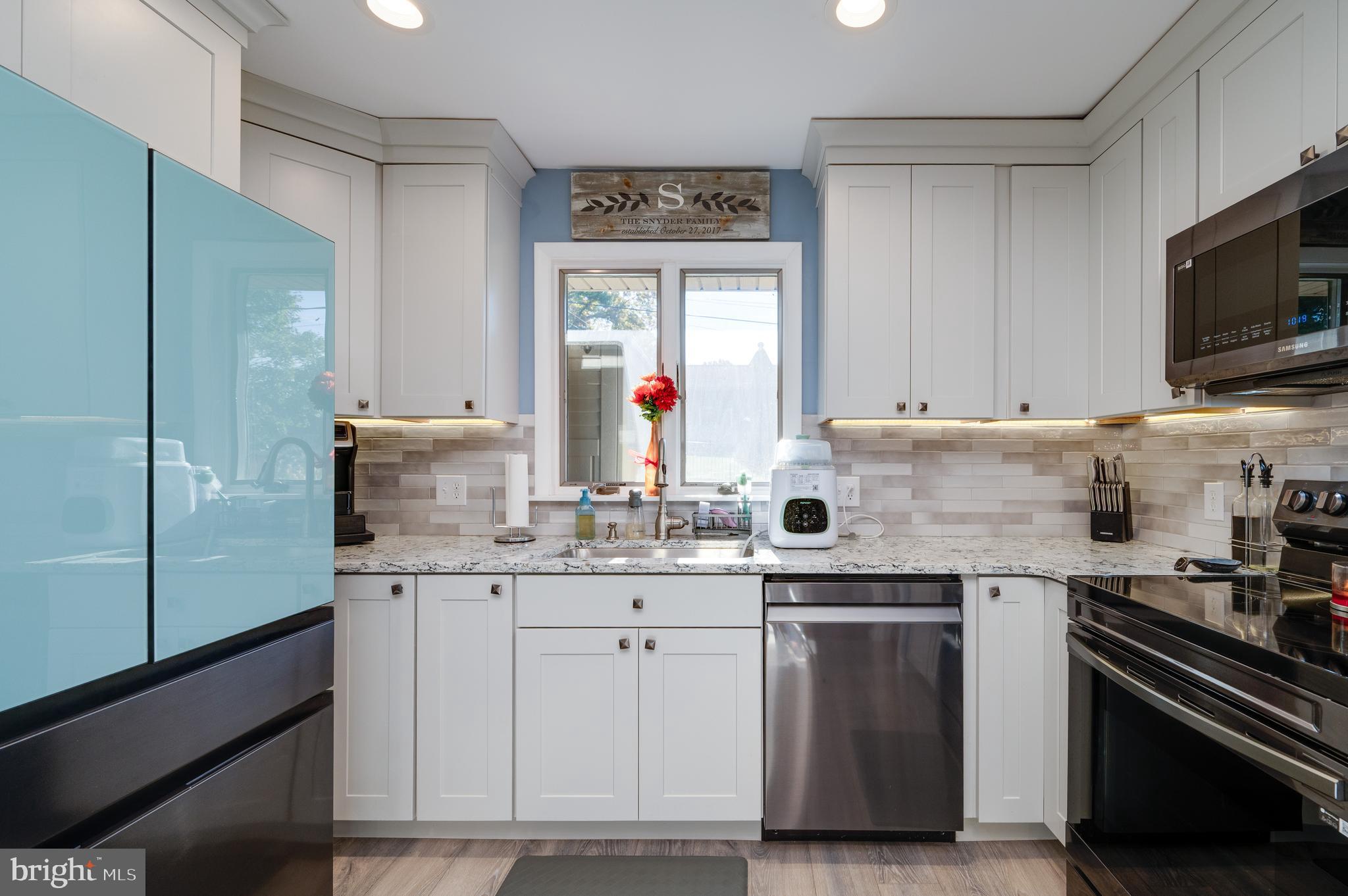 118 Octagon Avenue Sinking Spring, PA 19608 - Photo 18 of 45 a kitchen with granite countertop a sink stainless steel appliances and white cabinets