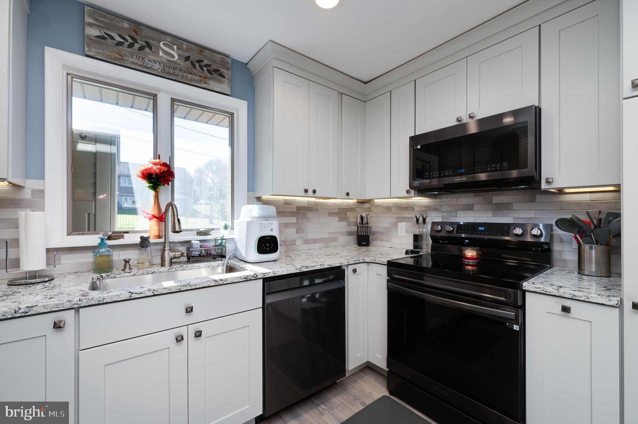 118 Octagon Avenue Sinking Spring, PA 19608 - Photo 20 of 45 a kitchen with stainless steel appliances a stove microwave and sink