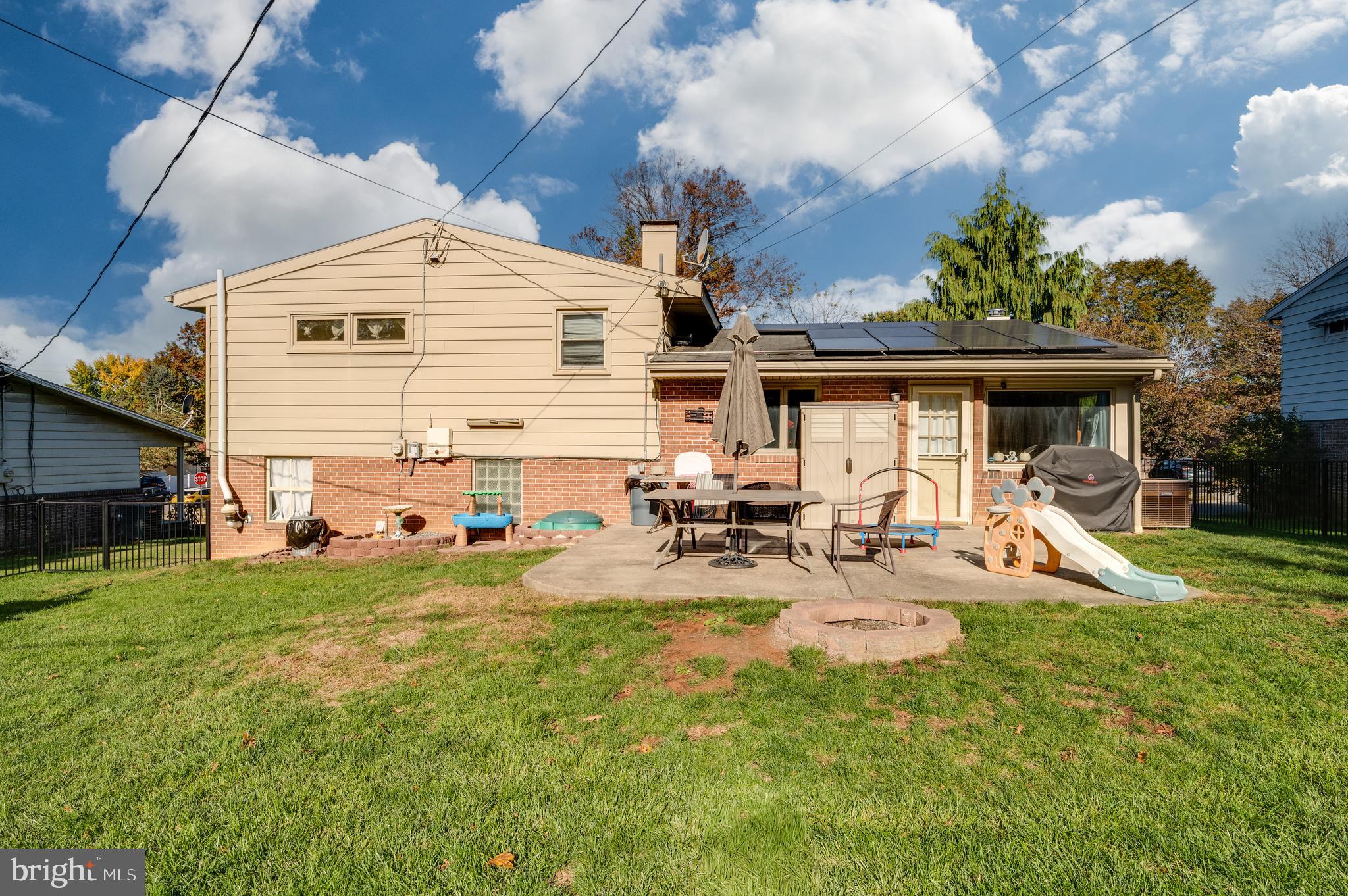 118 Octagon Avenue Sinking Spring, PA 19608 - Photo 37 of 45 a view of a backyard with table and chairs under an umbrella
