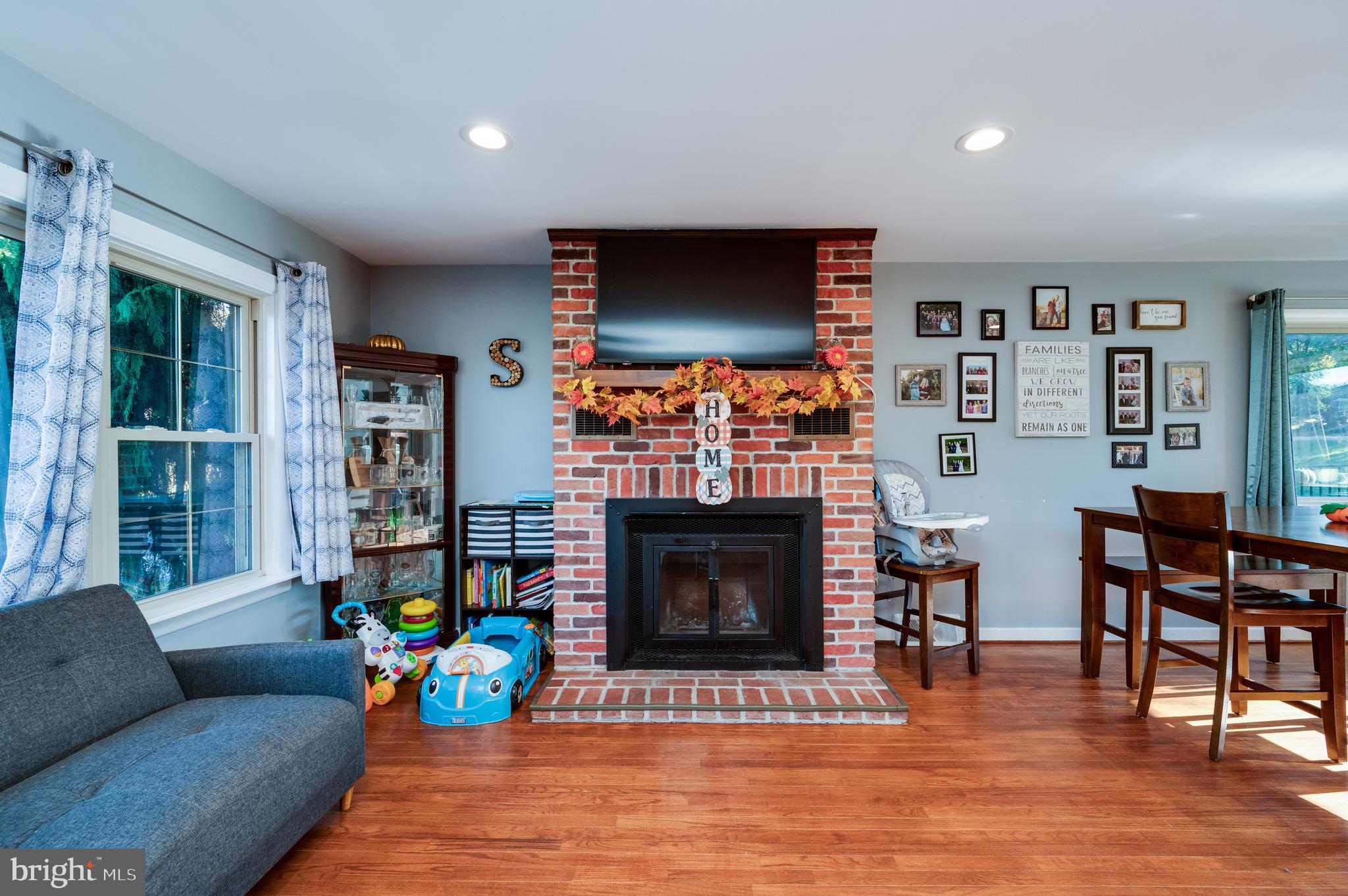 118 Octagon Avenue Sinking Spring, PA 19608 - Photo 5 of 45 a living room with furniture a flat screen tv and a fireplace