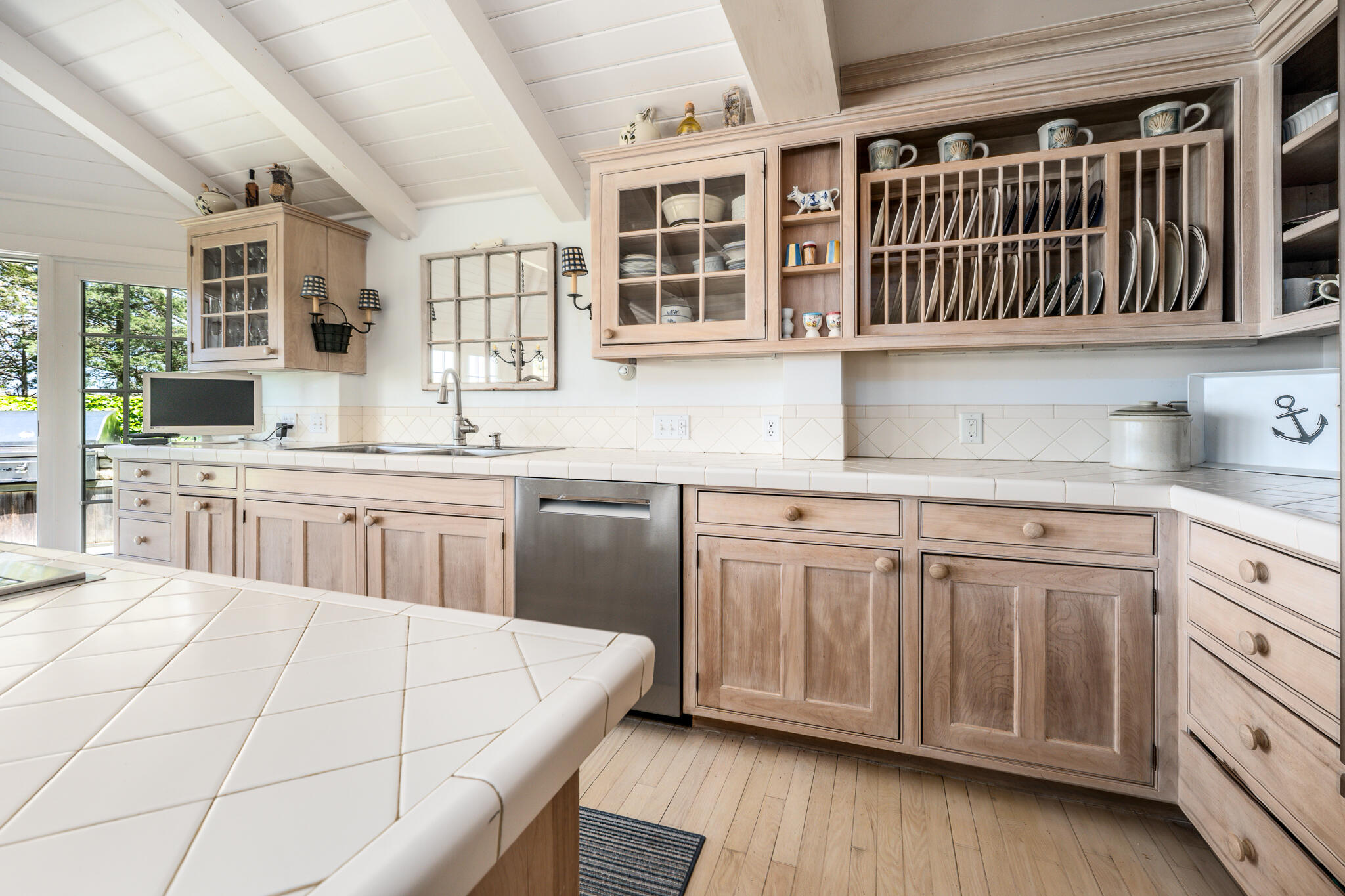 46 Great Bay Road Osterville, MA 02655 - Photo 11 of 54 a kitchen with stainless steel appliances granite countertop a stove a sink dishwasher and white cabinets with wooden floor