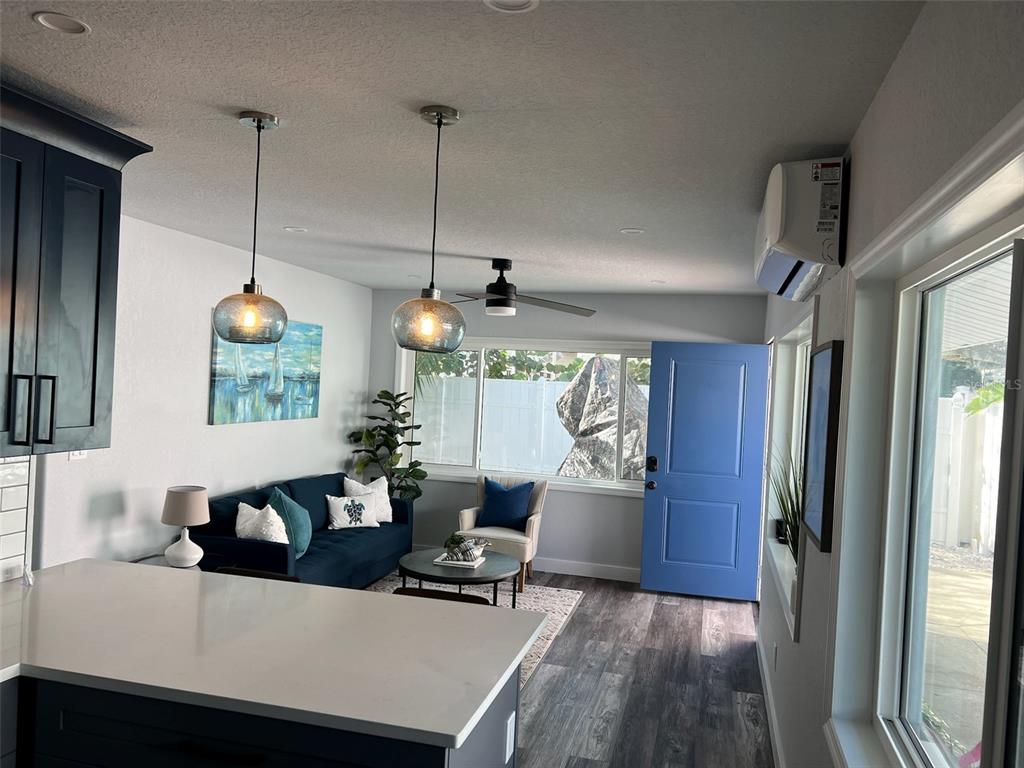 13246 4th Street East Madeira Beach, FL 33708 - Photo 16 of 23 a living room with furniture and a floor to ceiling window