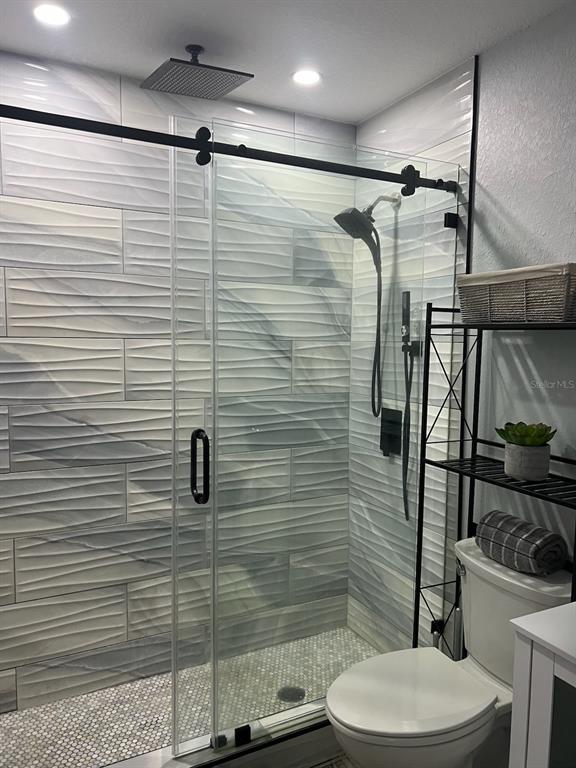 13246 4th Street East Madeira Beach, FL 33708 - Photo 21 of 23 a bathroom with a toilet and a shower