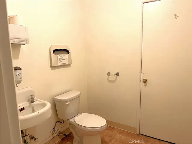 a white toilet sitting next to a bathroom sink