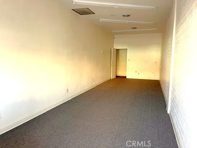 a view of an empty room and a window